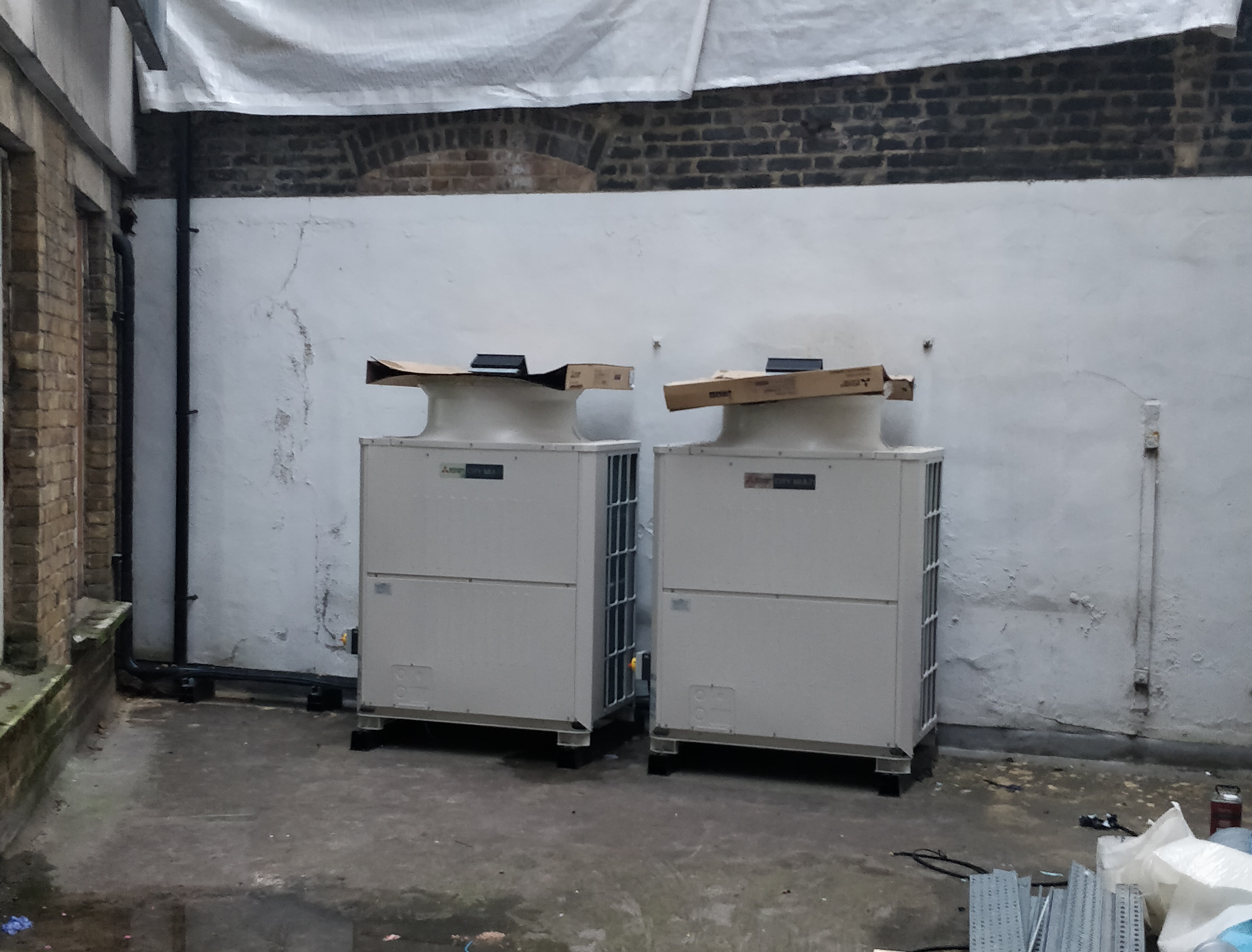 Wall-attached enclosure fitted to Mitsubishi unit